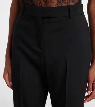Alexander Mcqueen Tailored Wool Trousers Featuring Flared Hem In Black