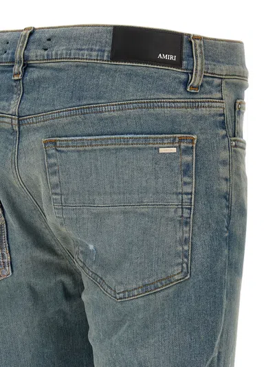Amiri Distressed Five-pocket Denim Trousers In Blue