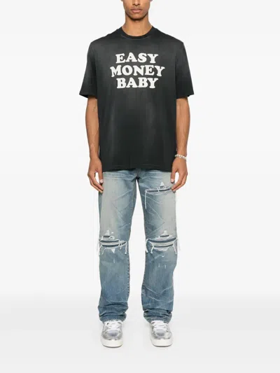 Amiri Men Blue Jeans With Ripped Details On The Front And Logo Patch On The Rear In Denim Man In Blue