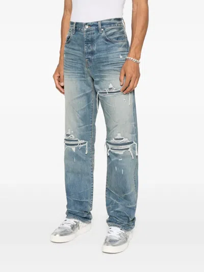 Amiri Men Blue Jeans With Ripped Details On The Front And Logo Patch On The Rear In Denim Man In Blue