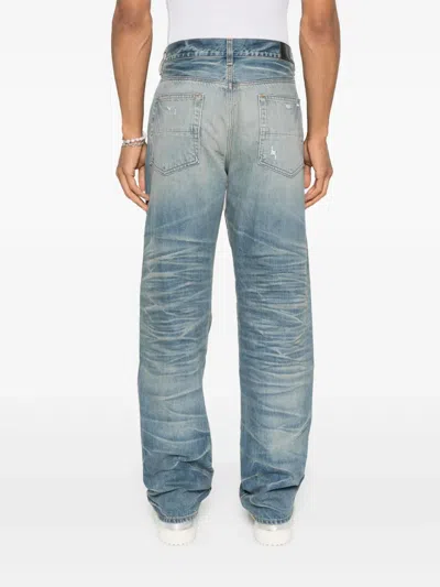 Amiri Men Blue Jeans With Ripped Details On The Front And Logo Patch On The Rear In Denim Man In Blue