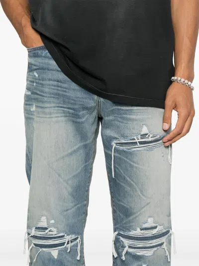 Amiri Men Blue Jeans With Ripped Details On The Front And Logo Patch On The Rear In Denim Man In Blue