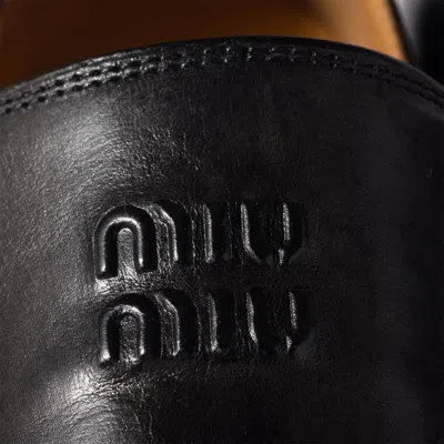 Miu Miu Embossed-logo Leather Loafers In Black