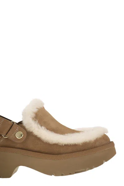 Ugg Suede Mules With Plush Trim And Adjustable Strap In Brown