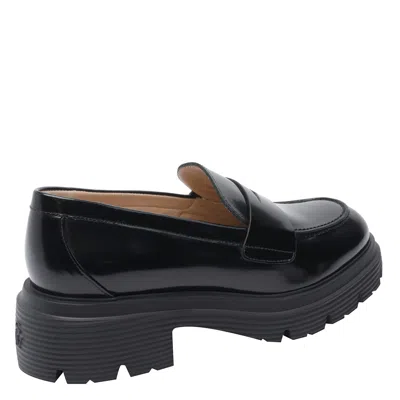 Stuart Weitzman Round Toe Chunky Sole Glossy Loafers In Black
