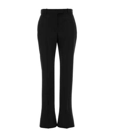 Alexander Mcqueen Tailored Wool Trousers Featuring Flared Hem In Black