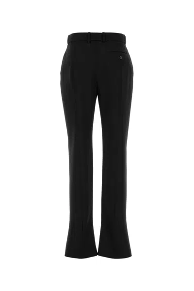Alexander Mcqueen Tailored Wool Trousers Featuring Flared Hem In Black