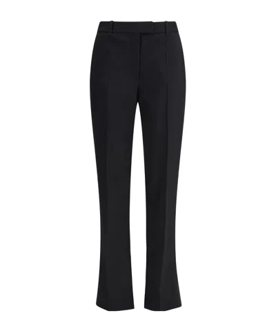 Alexander Mcqueen Tailored Wool Trousers Featuring Flared Hem In Black