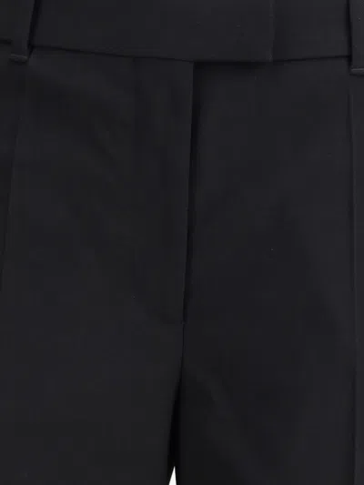 Alexander Mcqueen Tailored Wool Trousers Featuring Flared Hem In Black