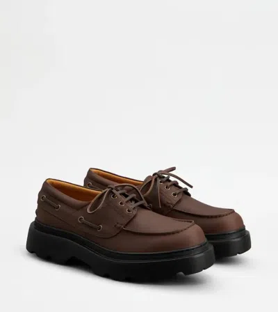 Tod's Boat Shoes With Chunky Sole And Eyelet Detailing In Brown