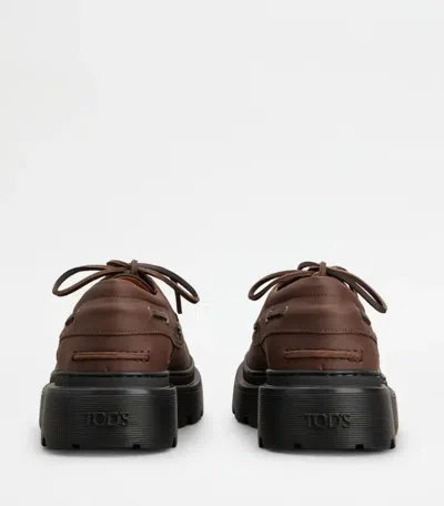 Tod's Boat Shoes With Chunky Sole And Eyelet Detailing In Brown