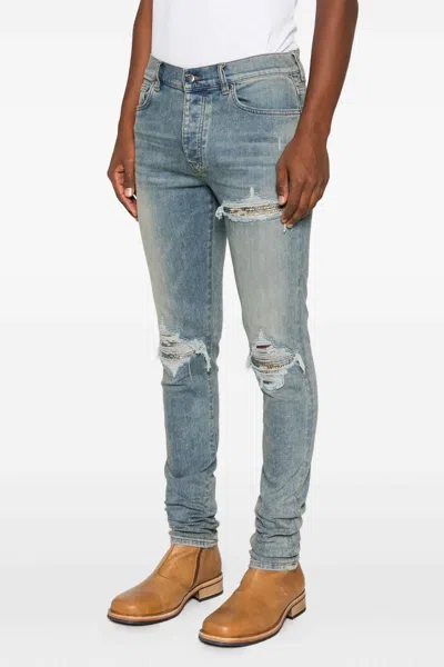 Amiri Distressed Five-pocket Denim Trousers In Blue