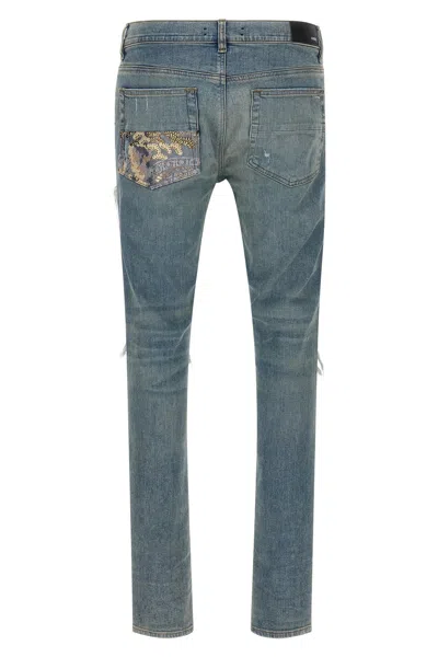 Amiri Distressed Five-pocket Denim Trousers In Blue