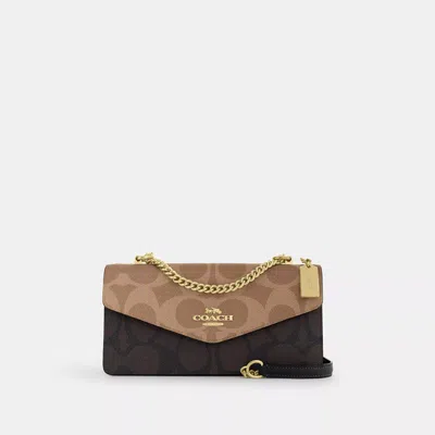 Coach Klare Envelope Crossbody Bag In Blocked Signature Canvas In Brown