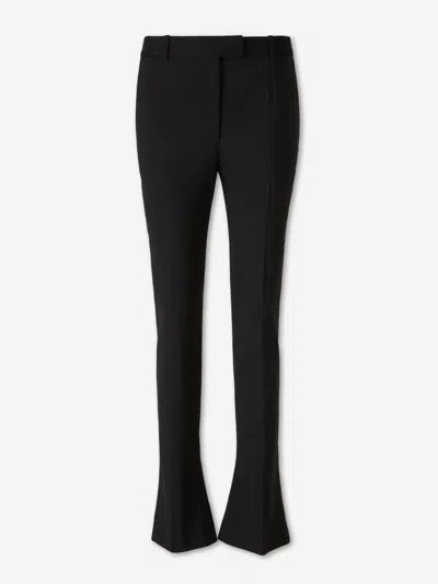 Alexander Mcqueen Tailored Wool Trousers Featuring Flared Hem In Black