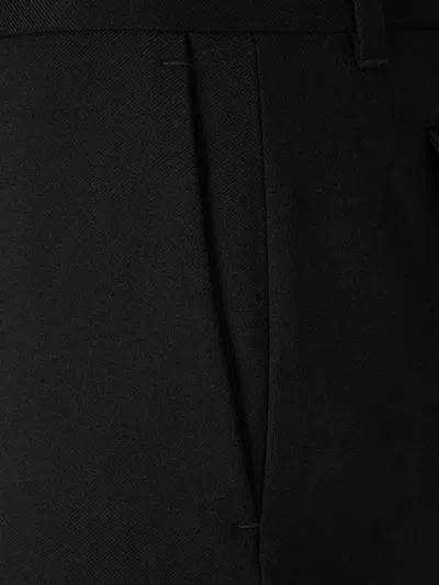 Alexander Mcqueen Tailored Wool Trousers Featuring Flared Hem In Black
