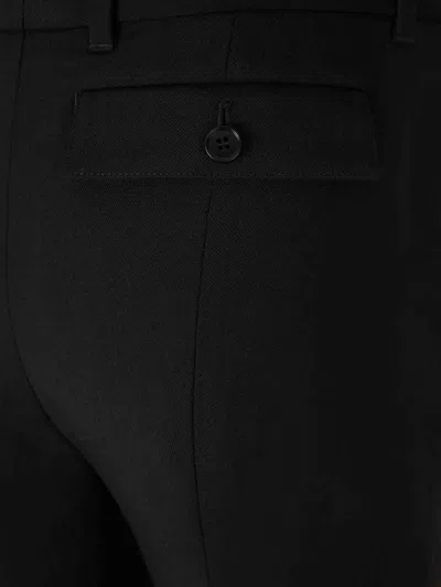 Alexander Mcqueen Tailored Wool Trousers Featuring Flared Hem In Black