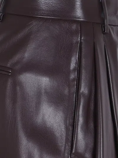 The Andamane Maxi Flare Vegan Leather Trousers In Brown