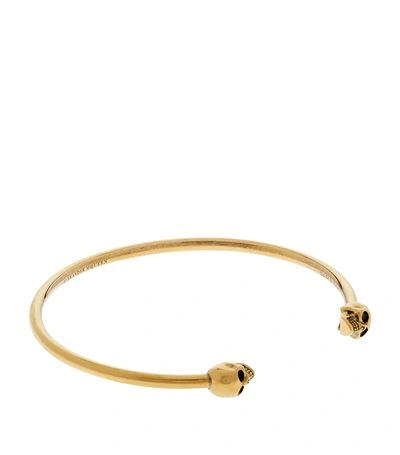 Alexander Mcqueen Gold Antiqued Thin Twin Skull Bracelet In 0448 - Gold