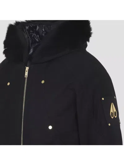 Moose Knuckles Fitted Hooded Jacket With Plush Fur Trim And Metallic Accents In Black