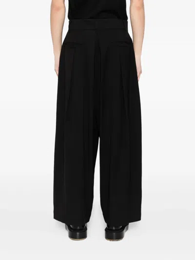 Songzio Asymmetric-wrap Trousers In Black