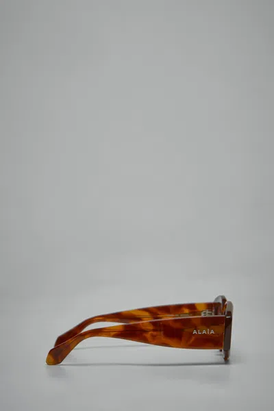 Alaïa Logo Sunglasses In Brown