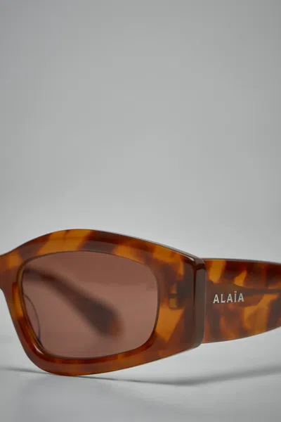Alaïa Logo Sunglasses In Brown