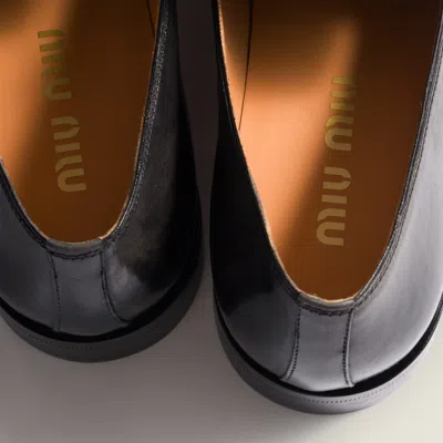 Miu Miu Embossed-logo Leather Loafers In Black