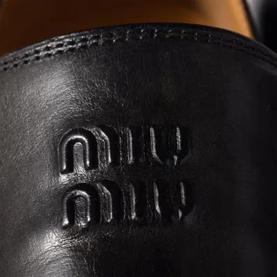 Miu Miu Embossed-logo Leather Loafers In Black