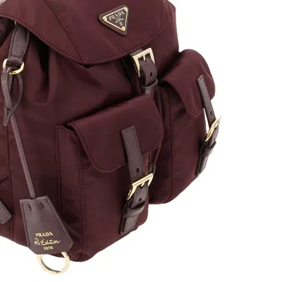 Prada Bordeaux Re-nylon Backpack With Golden Hardware In Red