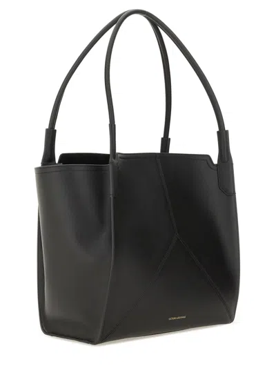 Victoria Beckham Victoria Black Handbag With V Stitching On The Front And Embossed Logo Lettering On The Front In Lea In Black