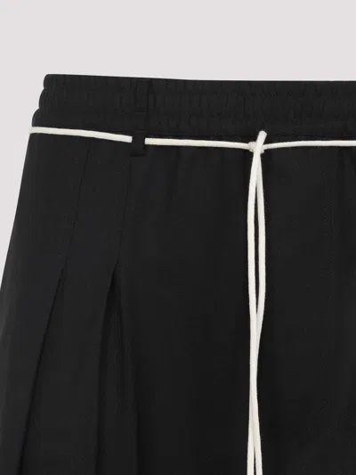 Mordecai Tapered Black Trousers With Pleated Front In Black