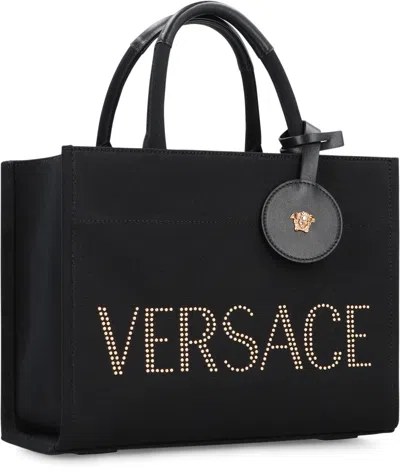 Versace Studded Logo Canvas Tote Bag In Black