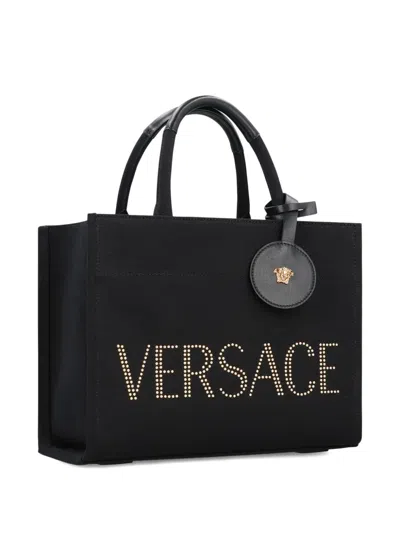 Versace Studded Logo Canvas Tote Bag In Black