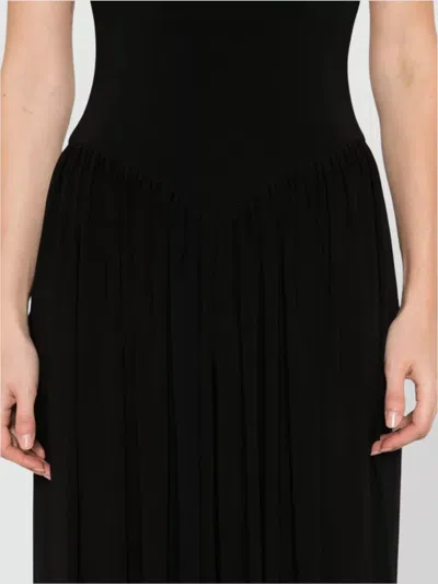 Norma Kamali Kelly Ankle Length Jumpsuit With Cross-back Design In Black