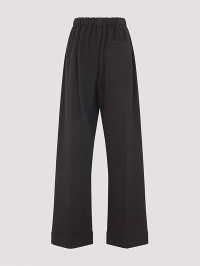 Carven Wide-leg Wool Trousers With Elastic Waistband And Buttoned Details In Black