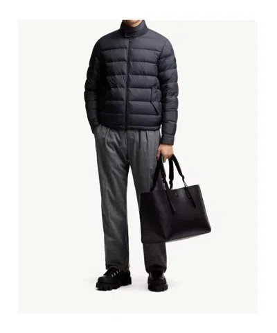 Moncler Quilted Down Jacket With High Collar And Logo Patch In Blue
