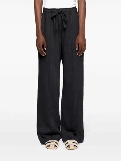 Jw Anderson J. W. Anderson Relaxed Wide-leg Trousers With Elastic Waistband In Black