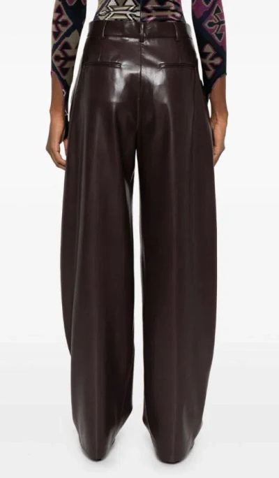 The Andamane Maxi Flare Vegan Leather Trousers In Brown