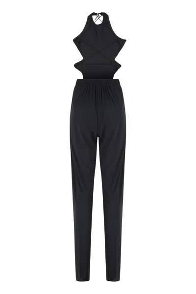 Amazuìn Sleek Elasticated Jumpsuit With Open Back And Draped Legs In Black