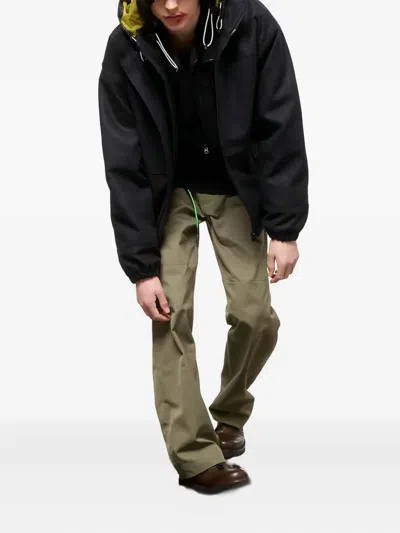 Gr10k Hooded Black Logo Jacket With Contrasting Lining And Adjustable Features In Black