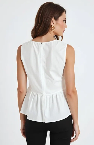 Modenaire Sleeveless Peplum Top With Asymmetric Pearl Button Front In White