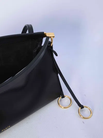 Alaïa Alaia Women East West Leather Shoulder Bag With Engraved Lettering Logo In Black