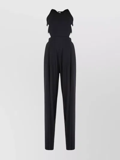 Amazuìn Sleek Elasticated Jumpsuit With Open Back And Draped Legs In Black