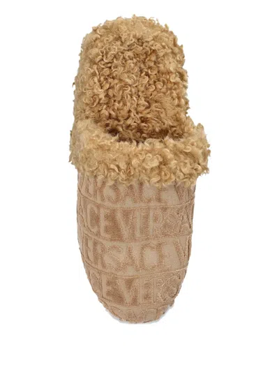 Versace Logo Curly Slippers In Nude