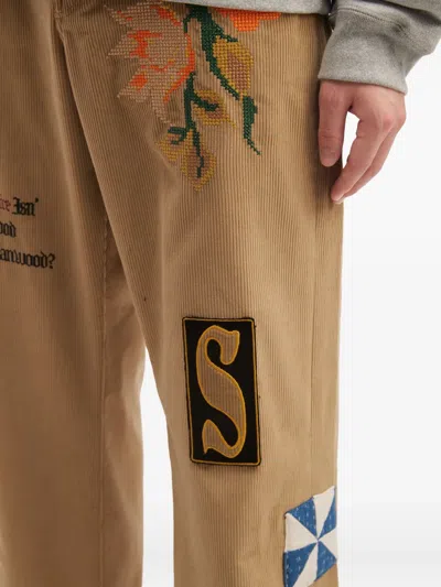 Khoki Floral-embroidery Patch-detail Trousers In Brown