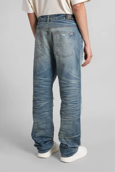 Amiri Men Blue Jeans With Ripped Details On The Front And Logo Patch On The Rear In Denim Man In Blue