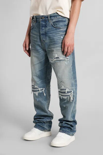Amiri Men Blue Jeans With Ripped Details On The Front And Logo Patch On The Rear In Denim Man In Blue