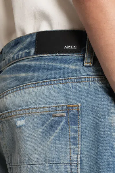 Amiri Men Blue Jeans With Ripped Details On The Front And Logo Patch On The Rear In Denim Man In Blue