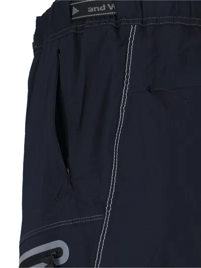 And Wander Streamlined Black Trousers With Zippered Pockets In Blue